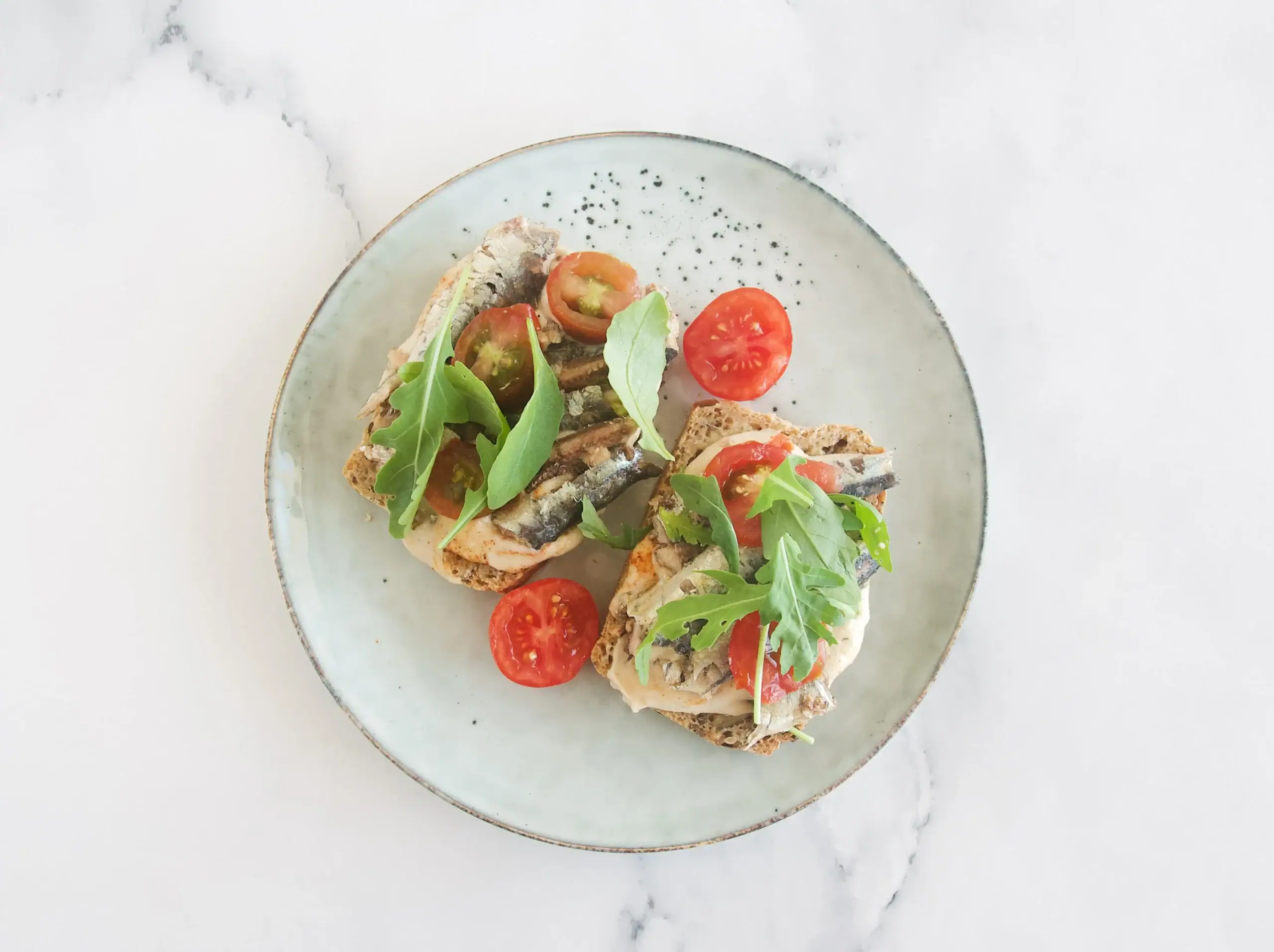 Tostada de hummus de alubias y sardinas